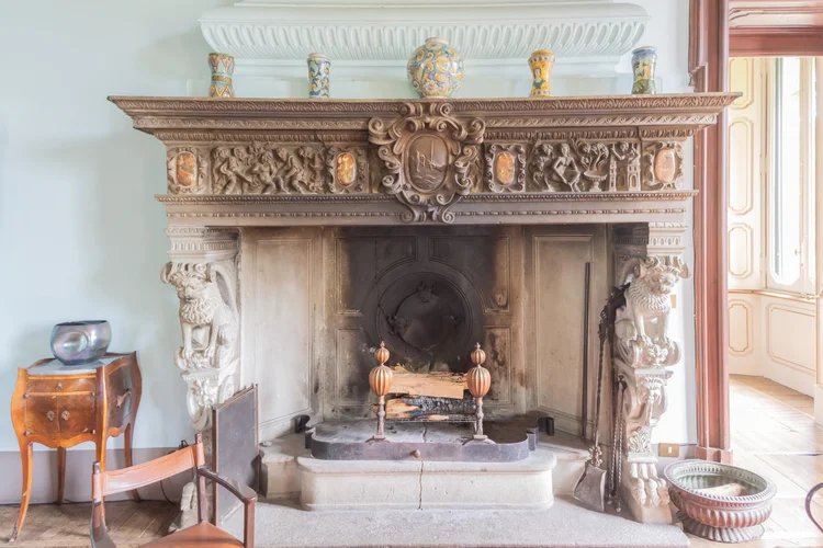 Carved stone fireplace in one of the salons